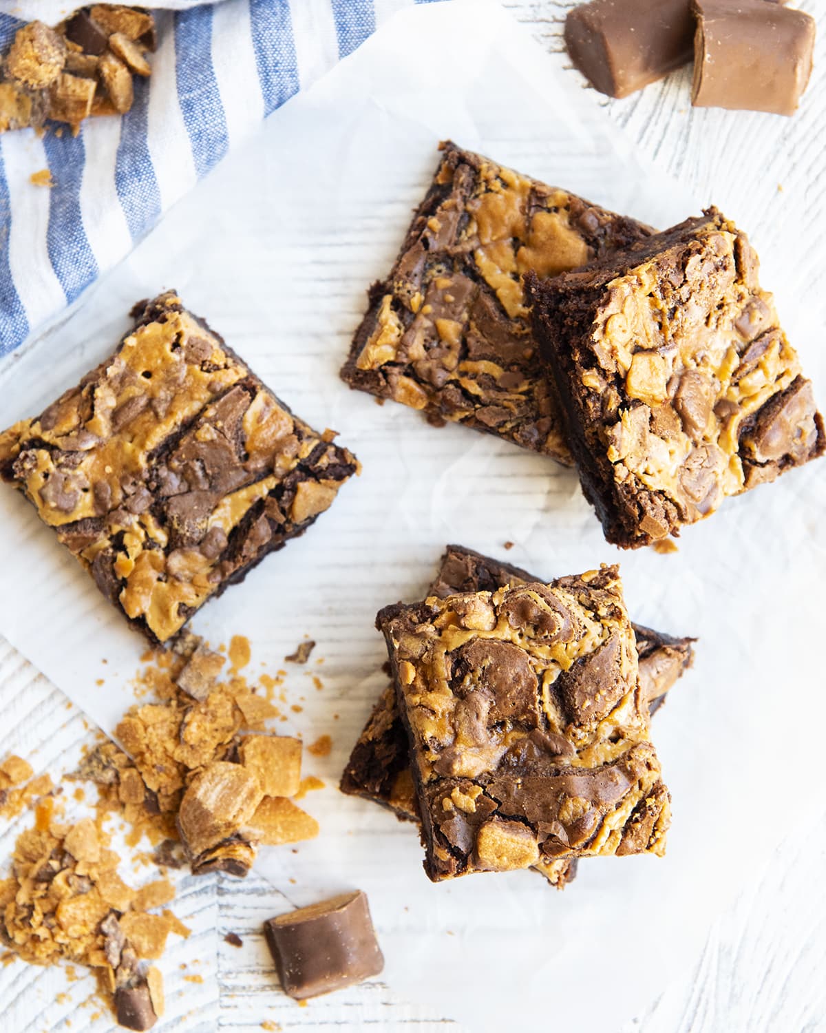 An overhead photo of Butterfinger brownies topped with peanut butter swirls.