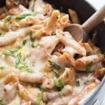Close up image of easy on pot pasta with melted cheese and wooden spoon.