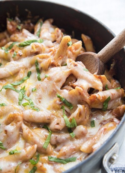 Close up image of easy on pot pasta with melted cheese and wooden spoon.