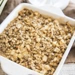 Above image of baked apple cinnamon oatmeal in a square white baking dish.