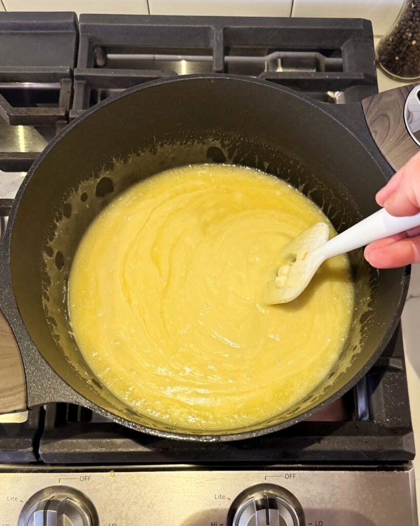 Eggnog fudge cooking in a pot.