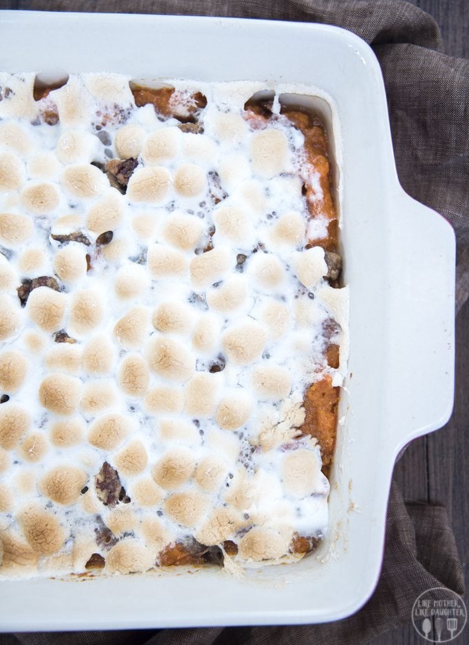 An overhead photo of sweet potato casserole in a baking dish, topped with toasted marshmallows.