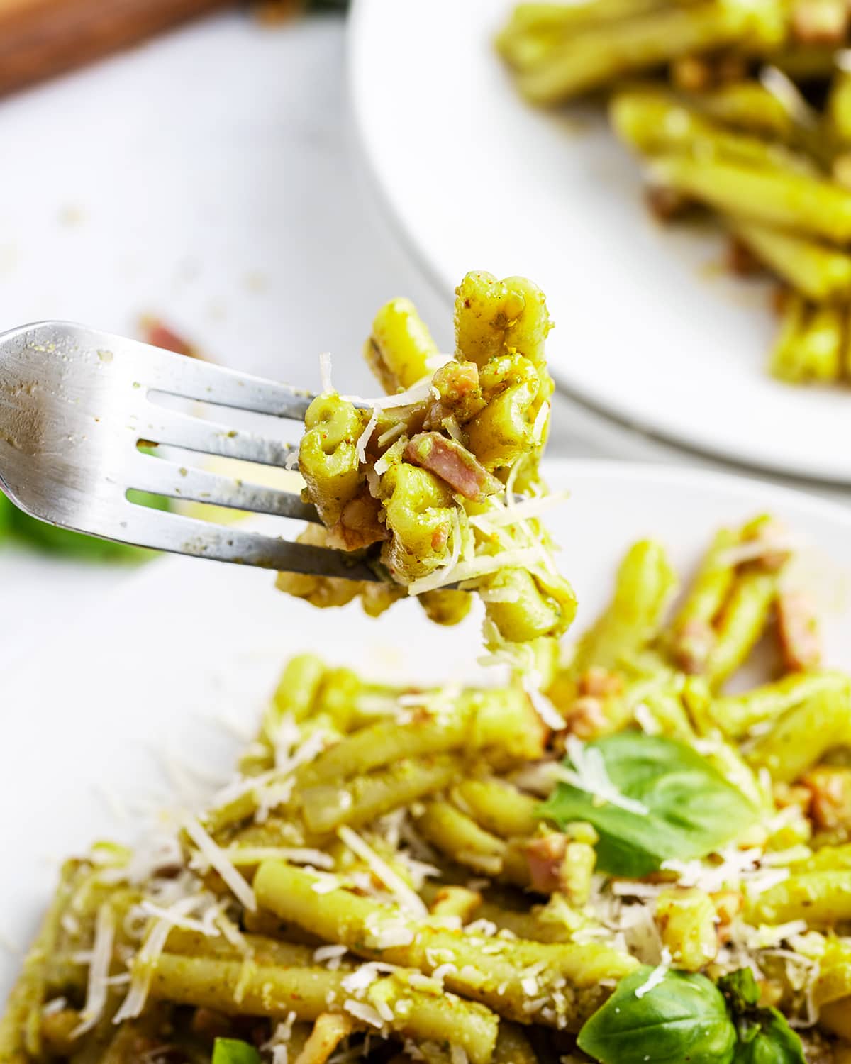 A forkful of casarecce Pasta with Basil Pesto sauce.