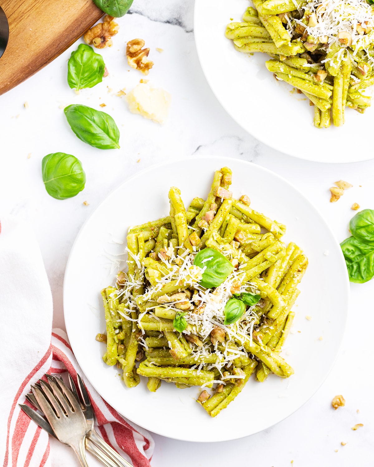 An overhead photo of two plates of Pesto Casarecce Pasta.