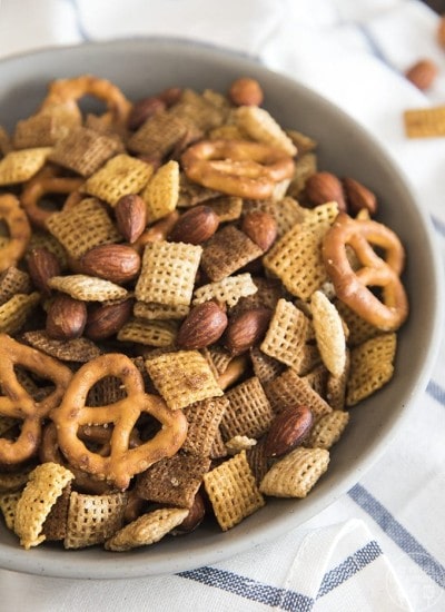 A gray bowl full of a savory chex mix.