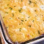 Angled view of cheesy scalloped potatoes in a baking pan.