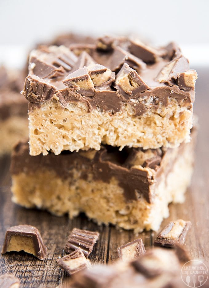 A stack of two peanut butter rice krispie treats topped with chocolate and peanut butter cups.