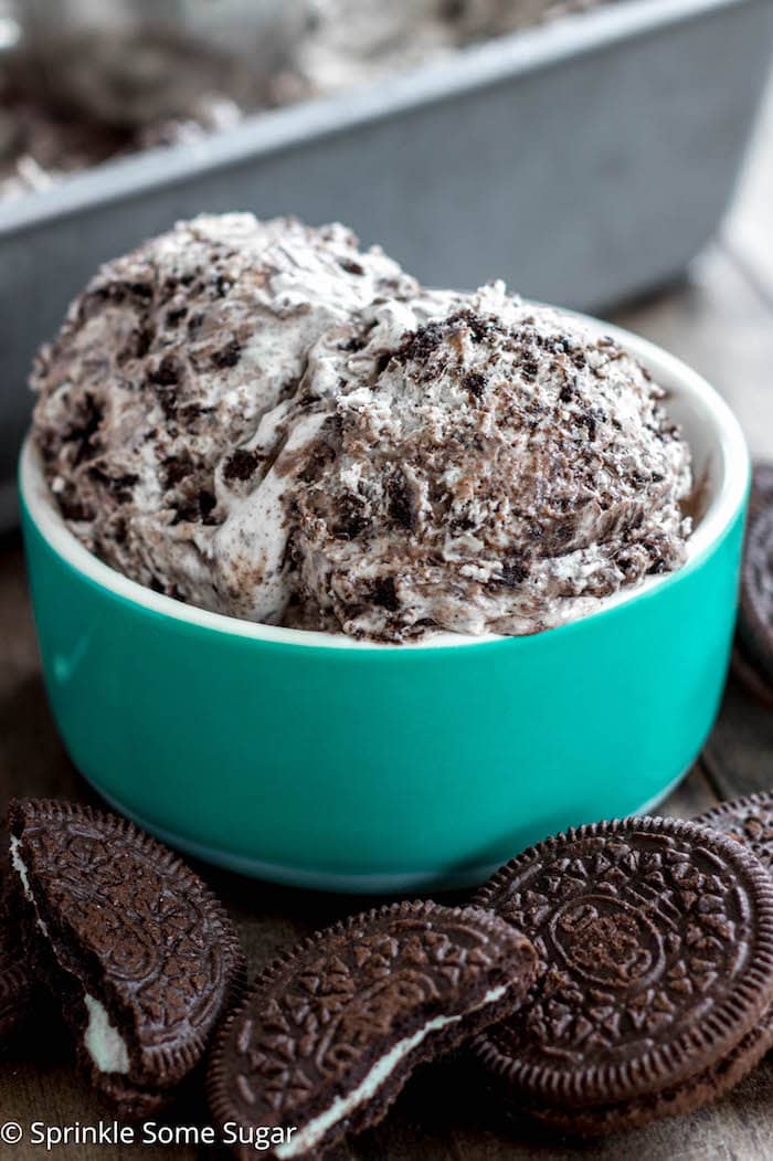 A bowl full of big scoops of cookies and cream ice cream. 