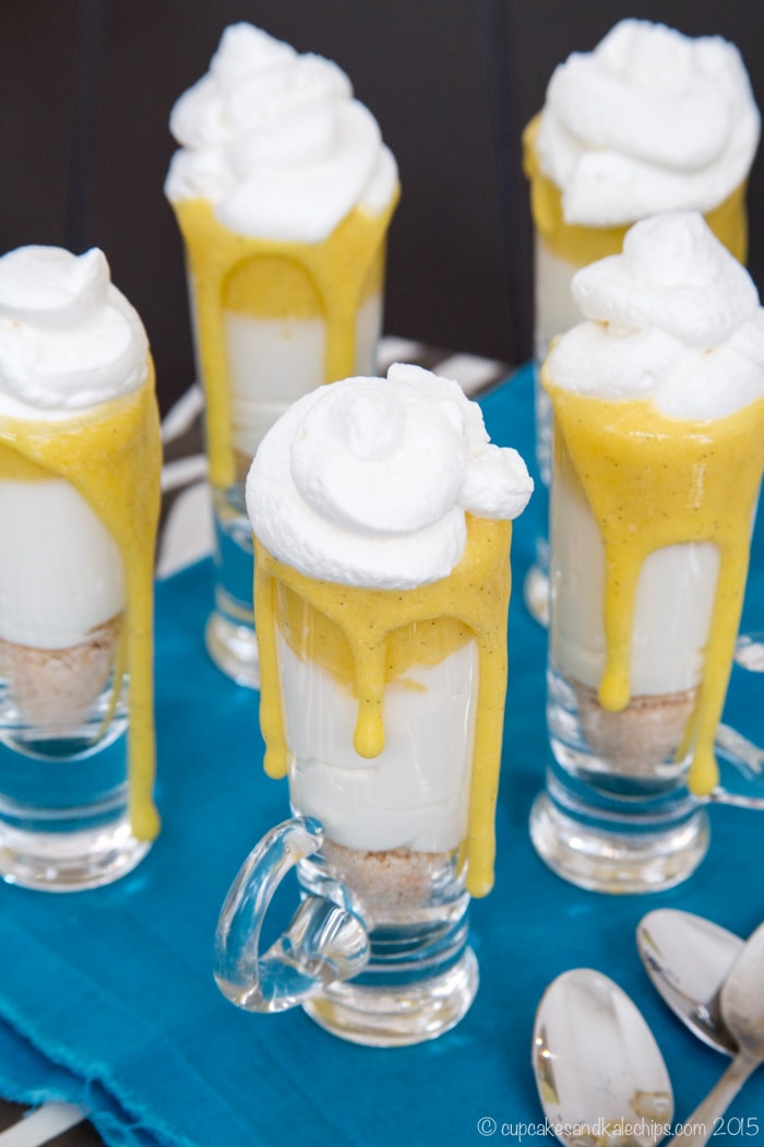 Cheesecake parfaits topped with lemon curd and whipped cream. 