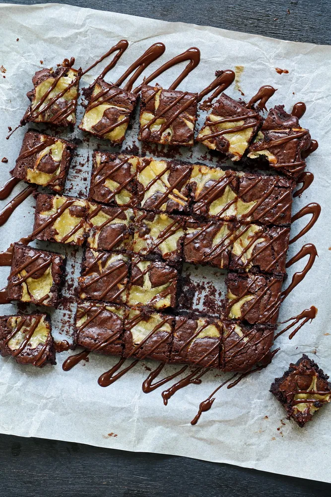 An overhead photo of brownies with lemon curd swirled throughout, and cut into pieces.