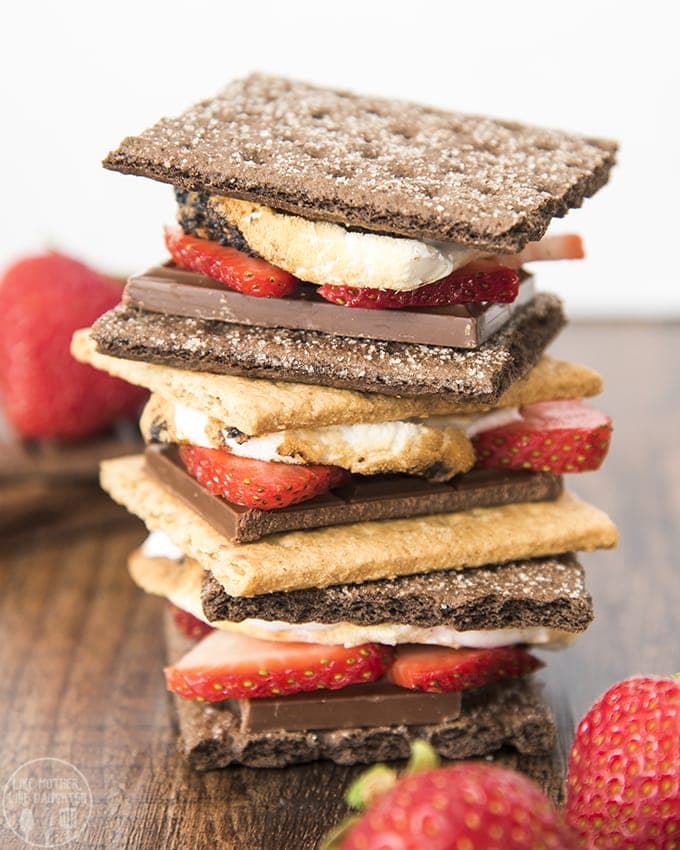 A stack of s\'mores made with strawberries in them. 