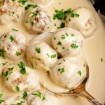 Swedish meatballs in a pot, in a creamy white gravy sauce, and sprinkled with fresh parsley.