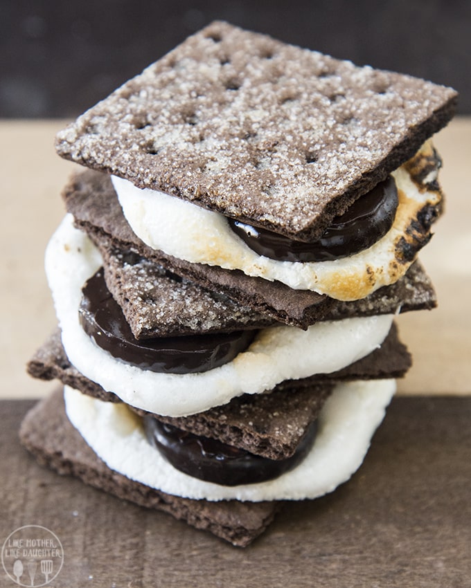 A stack of chocolate graham cracker smores filled with marshmallows and peppermint patty chocolates.