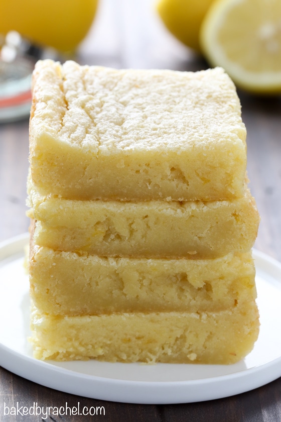 A stack of four lemon blondies on a plate. 