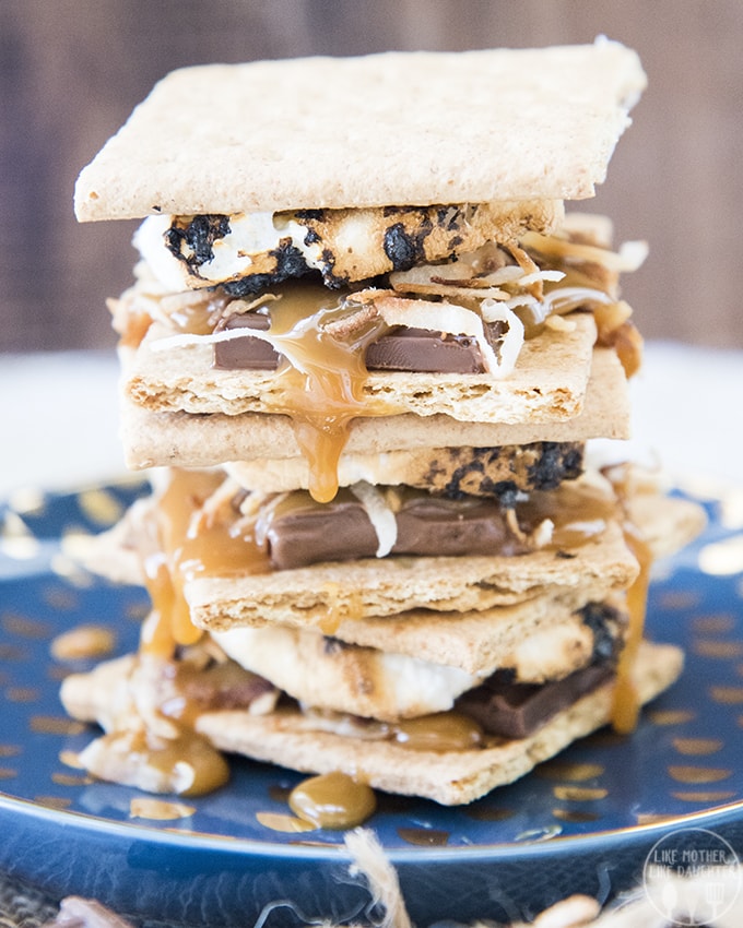 A stack of Samoa S\'mores with coconut, toasted marshmallows, caramel, and chocolate.