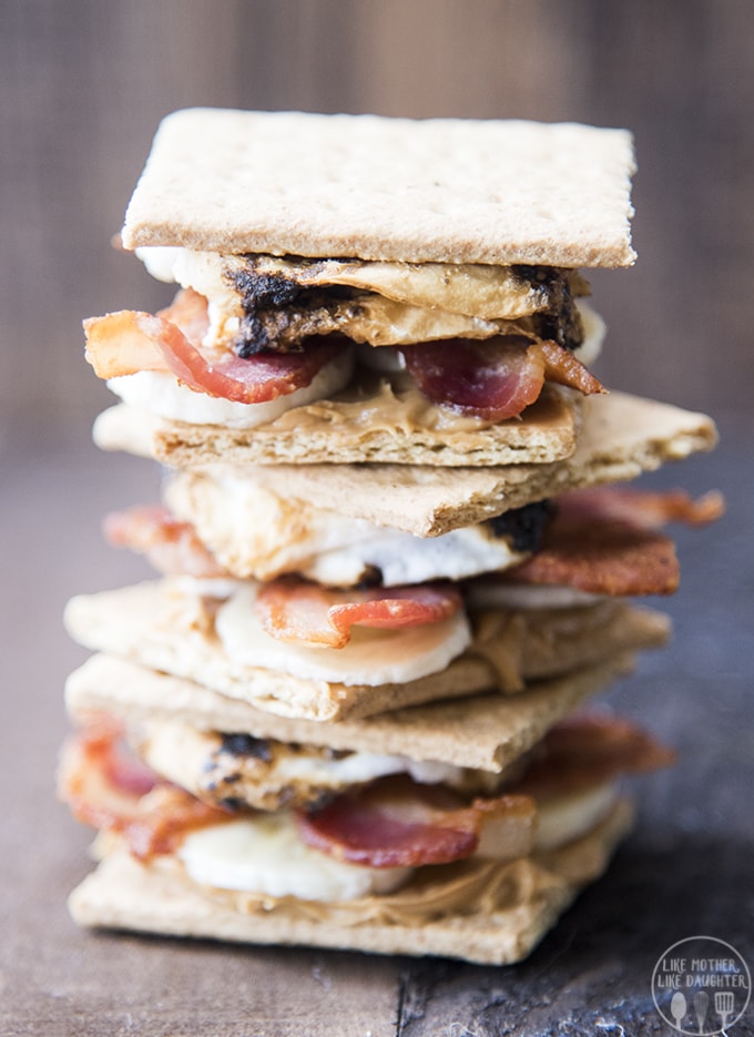 A stack of s\'mores made with peanut butter and bacon in the middle. 
