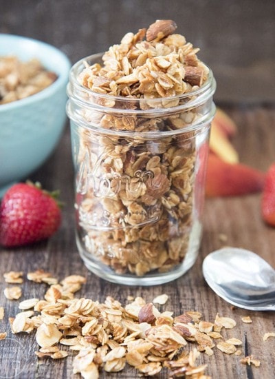 A glass jar filled with homemade coconut almond granola.