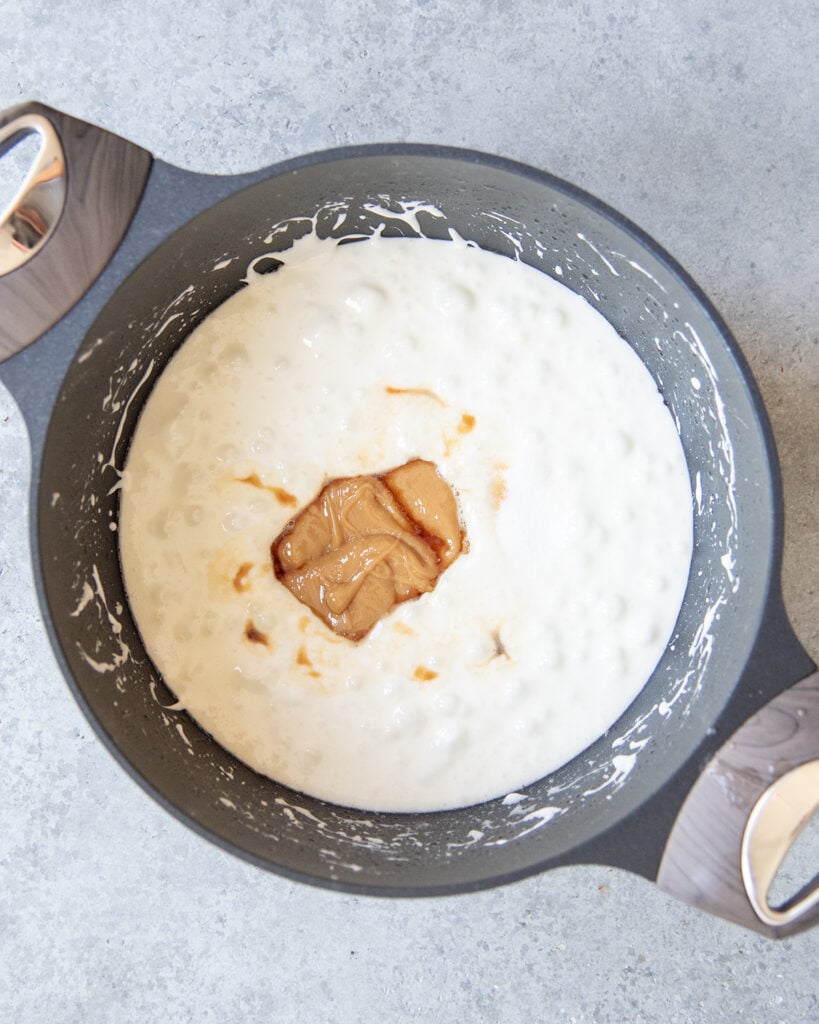 An above view of a pot of melted marshmallows, with a dollop of caramel sauce in the middle.