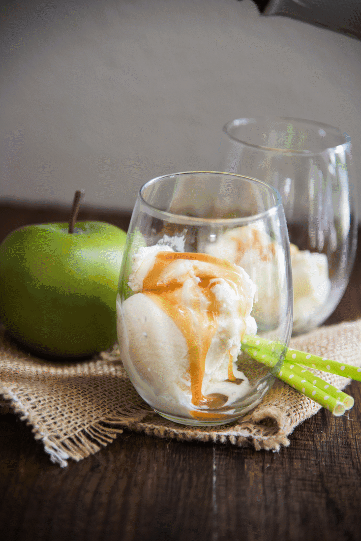 A gif showing ice cream in a glass with caramel and apple cider being poured over the top.