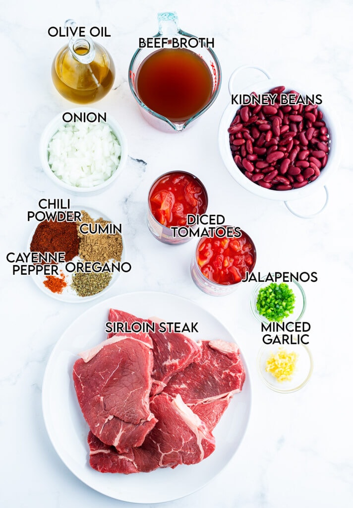 The ingredients needed to make steak chili in small bowls. 