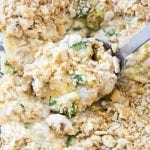 A scoop of broccoli and chicken casserole topped with cracker pieces.