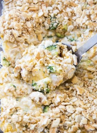 A scoop of broccoli and chicken casserole topped with cracker pieces.