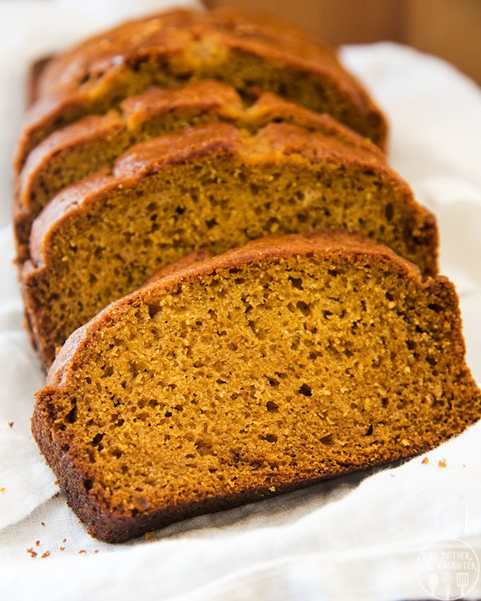 Pumpkin bread slices on a white cloth.