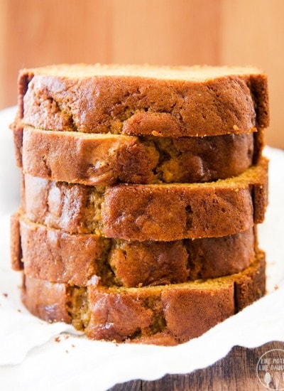 A stack of 5 pieces of pumpkin sweet bread.