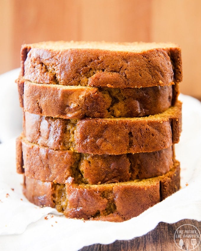 A stack of 5 pieces of pumpkin sweet bread.