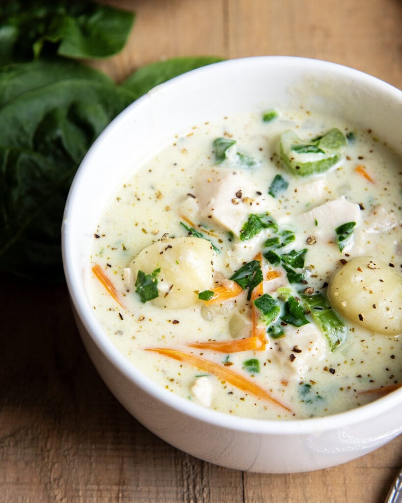 A close up of chicken gnocchi soup like olive garden.