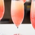 Three glasses of grapefruit sunrise cocktails.