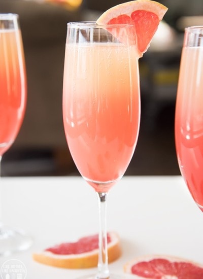 Three glasses of grapefruit sunrise cocktails.