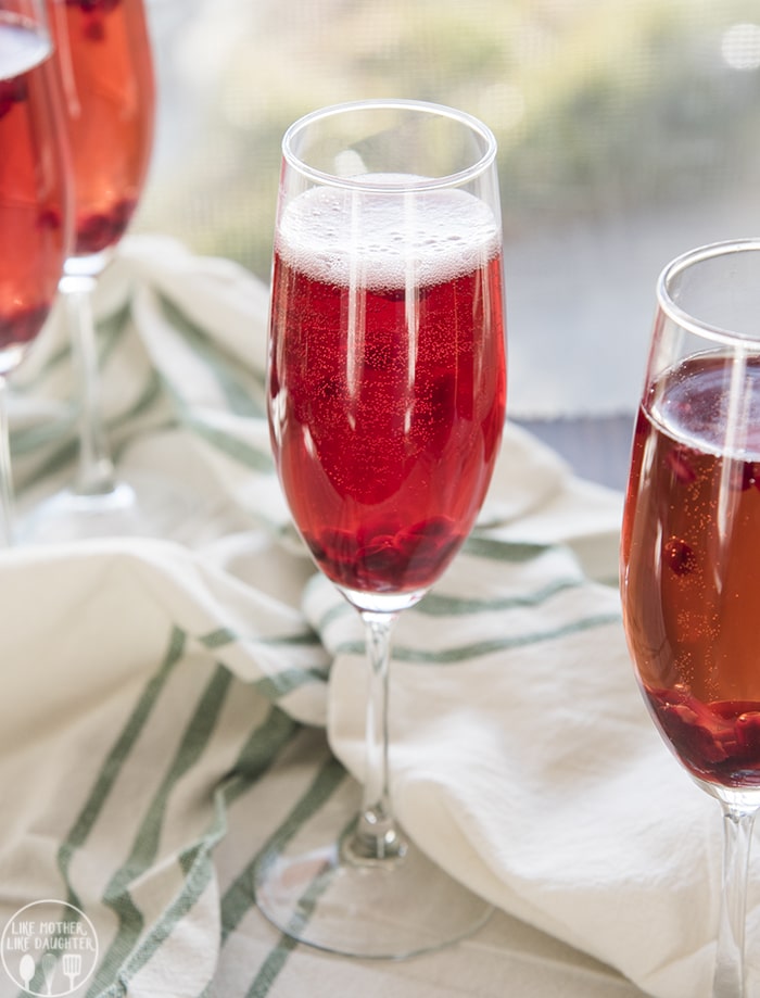 Three glasses of a sparkling pomegranate cocktail. 