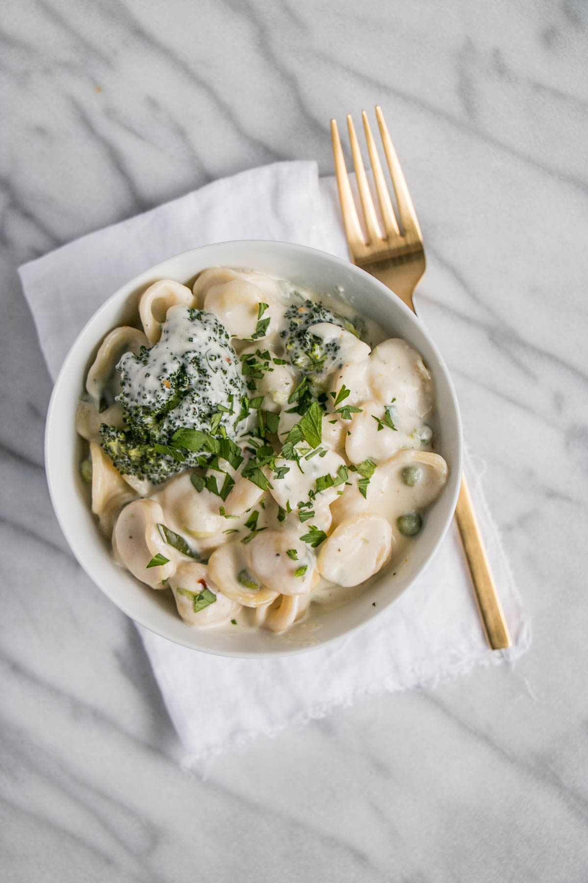 A bowl of one pot cheesy pasta and broccoli. 