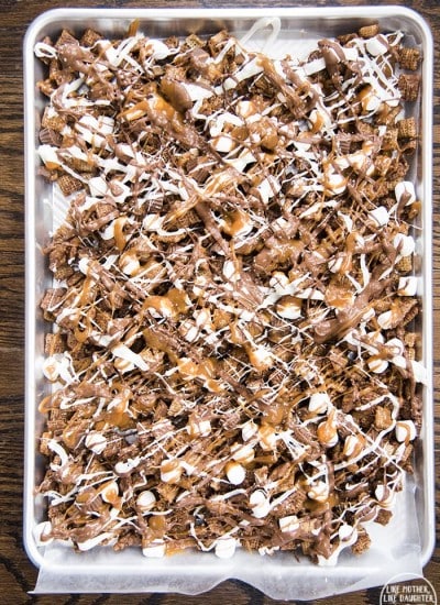 A baking pan topped with better than sex chex mix.