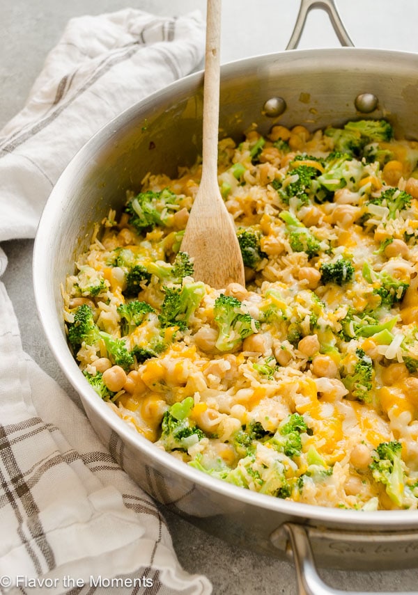 A pot of broccoli and rice casserole topped with cheese. 