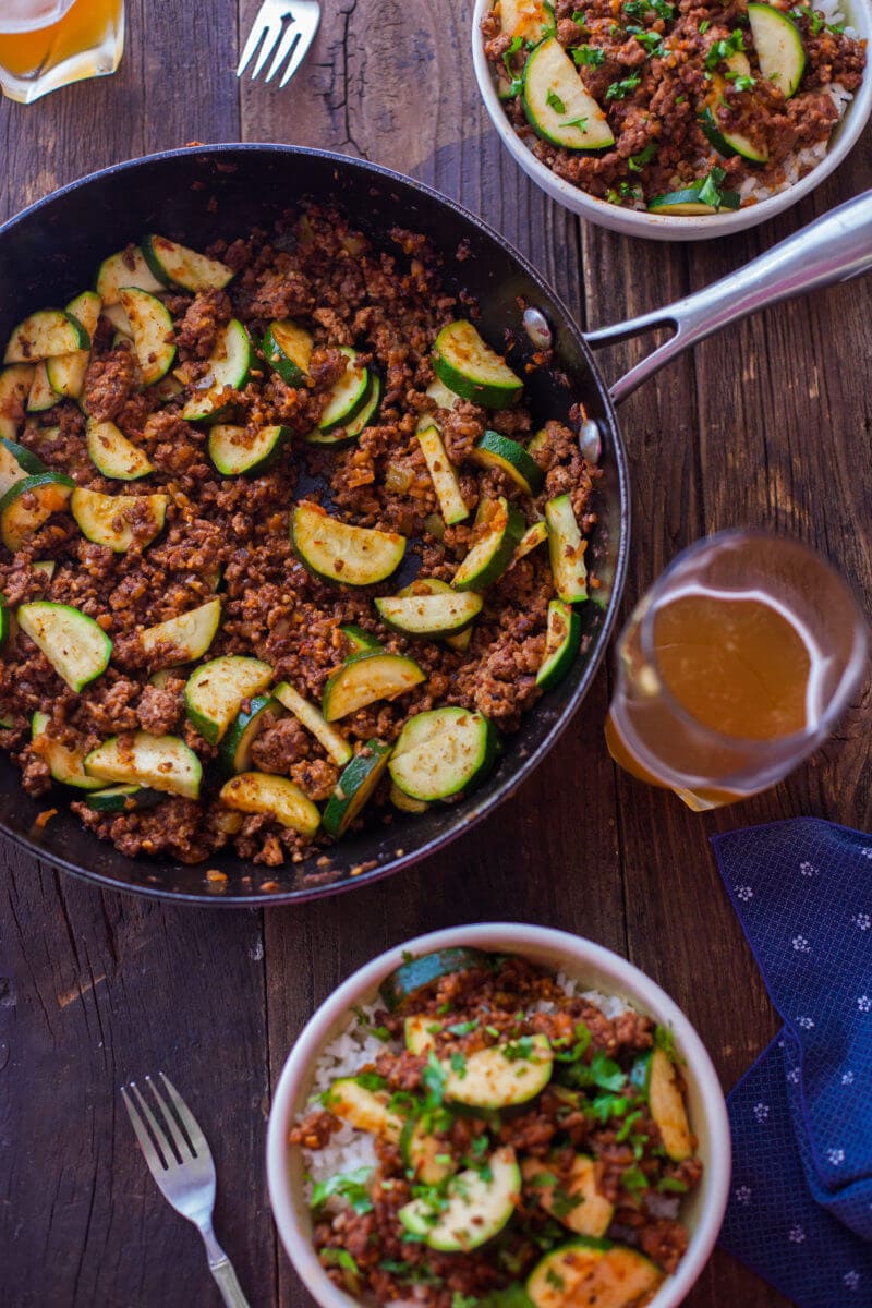 A pan of zucchini and ground beef mixed together.