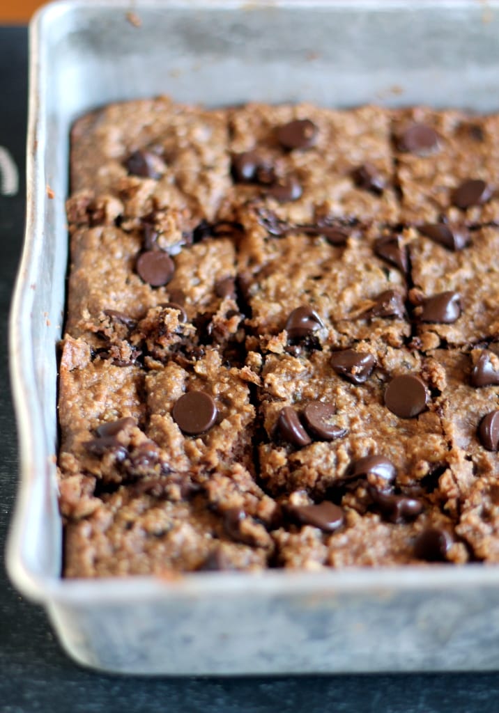 A pan of lentil peanut butter and chocolate chip blondies cut into pieces. 