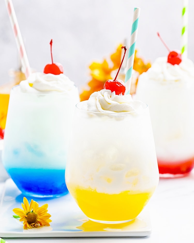 Cups of yellow, blue, and red Italian sodas.