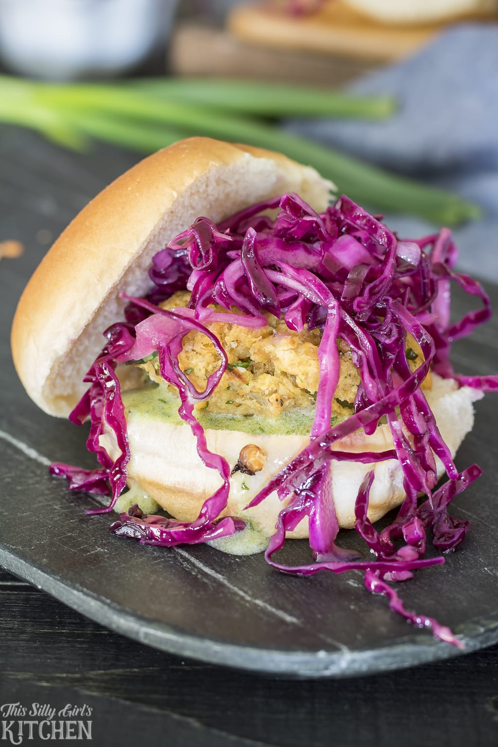A lentil burger topped with red cabbage.