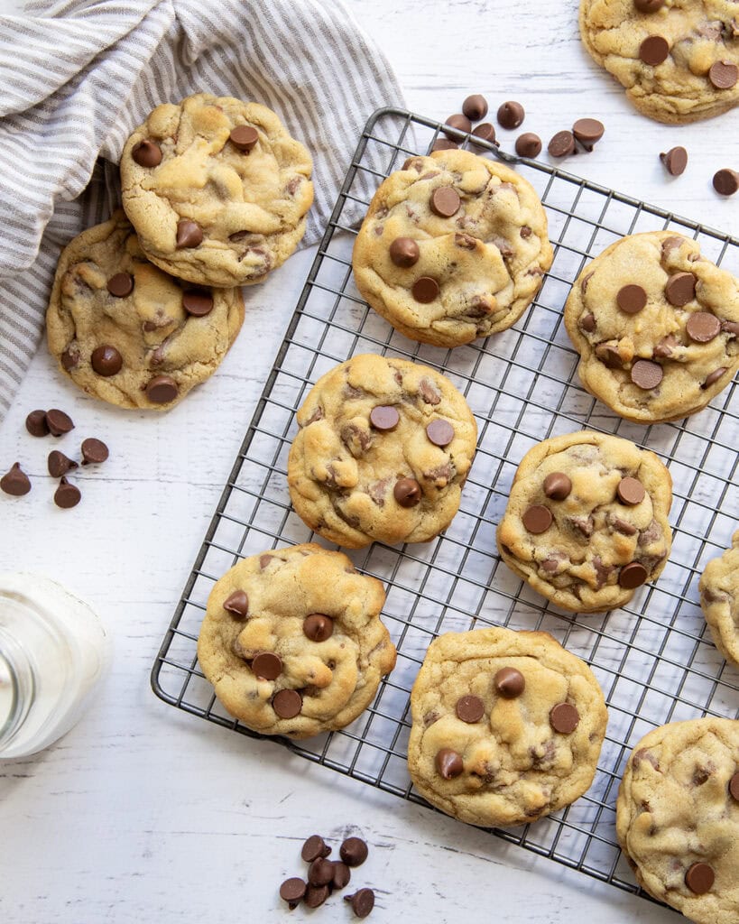 An above view of NYC bakery style chocolate chip cookies on a metal cooling rack.