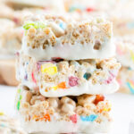 A stack of three white chocolate lucky charms rice krispie treats.