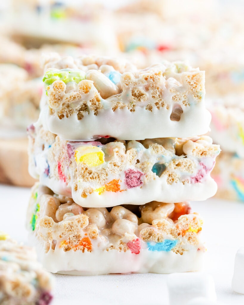 A stack of three white chocolate lucky charms rice krispie treats.