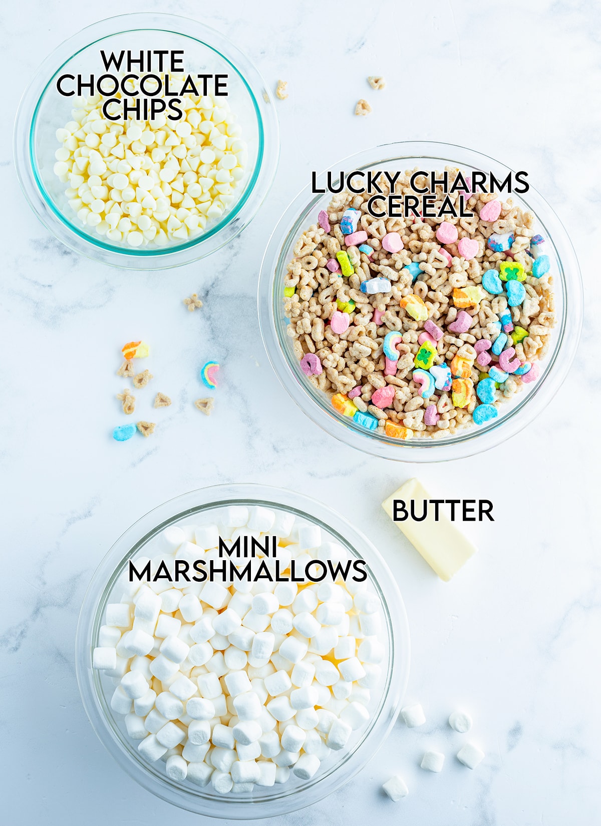 An overhead photo of the 4 ingredients needed to make Lucky Charms Rice Krispie Treats.