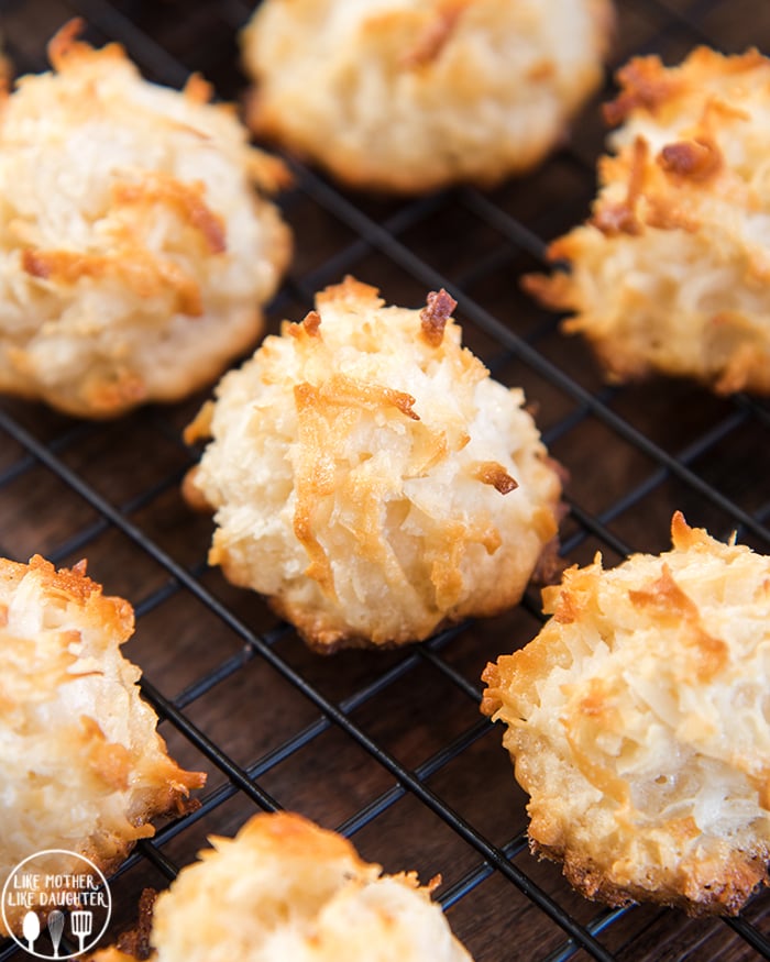A cooling rack topped with lightly golden coconut macaroons. 