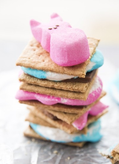 A stack of smores made with blue and pink peeps with a bunny peep on top.