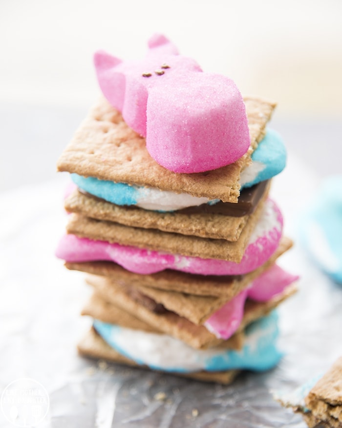 A stack of smores made with blue and pink peeps with a bunny peep on top.