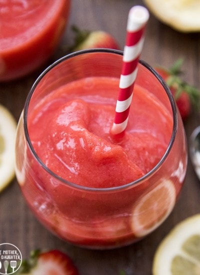 A glass full of frozen strawberry lemonade.