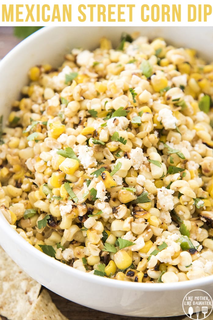 A white bowl filled with Mexican street corn dip.