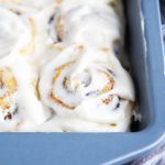 No Yeast Cinnamon Rolls topped with frosting in a square baking pan.